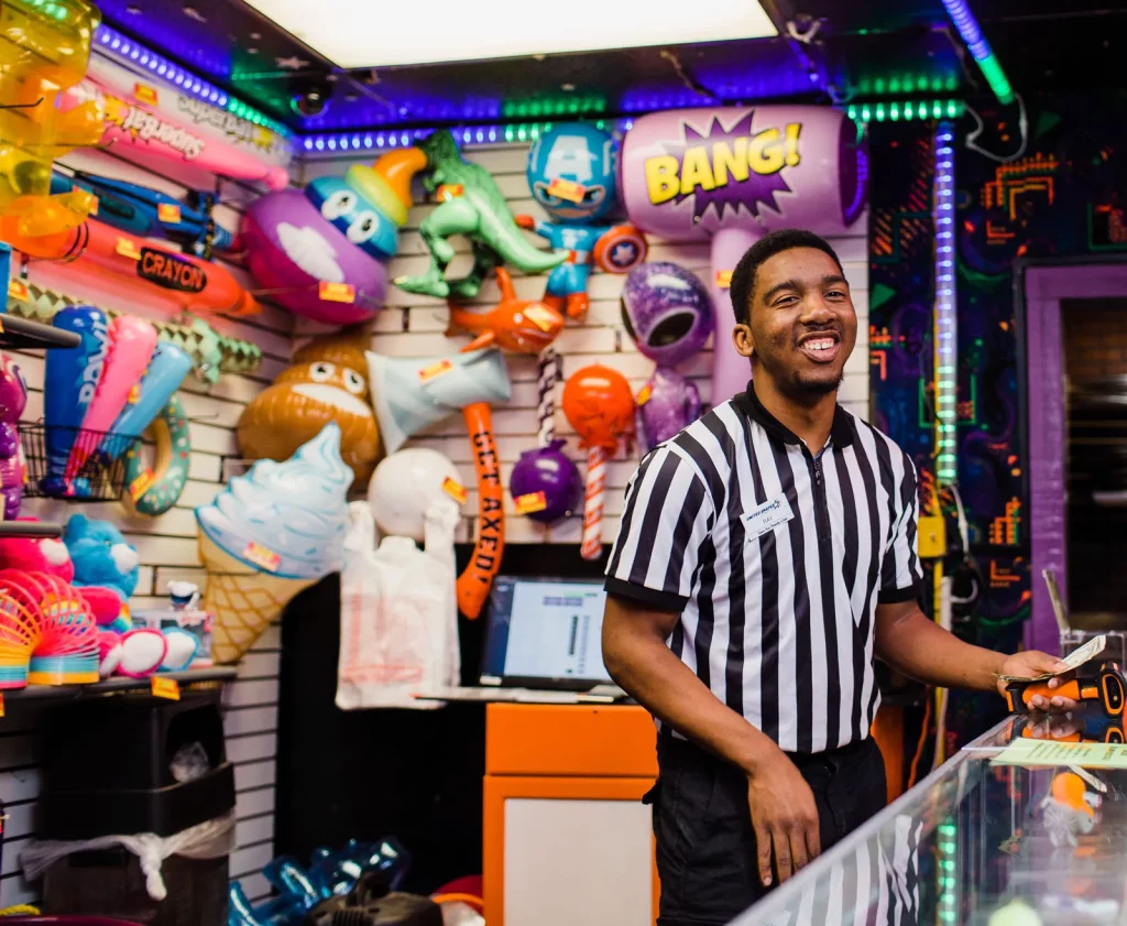 employee behind the counter at the prize shop