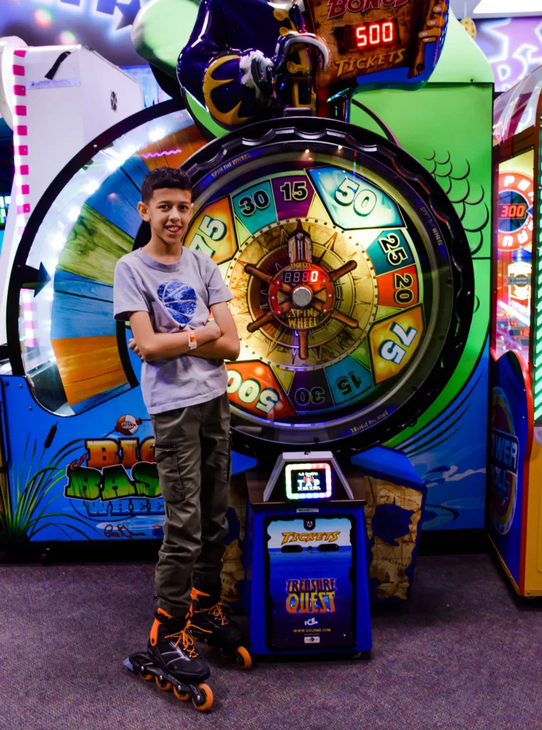 boy about to spin the arcade wheel to win tickets