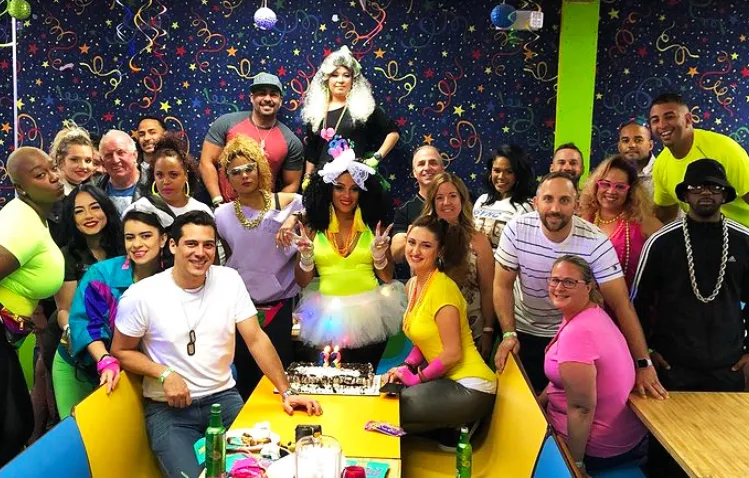 large group of people posing at a skating party