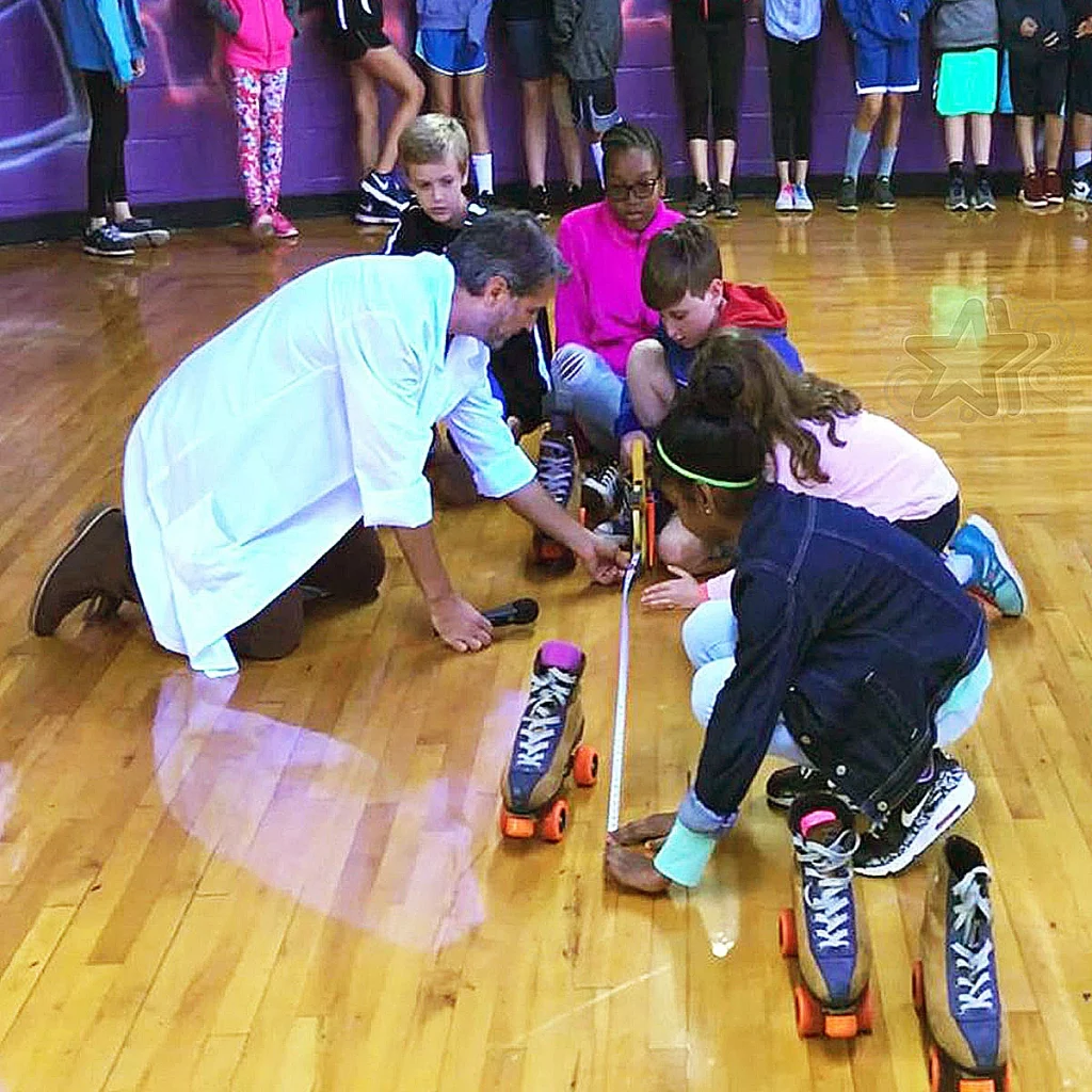 Stem Instructor Working With Kids on Rink Floor