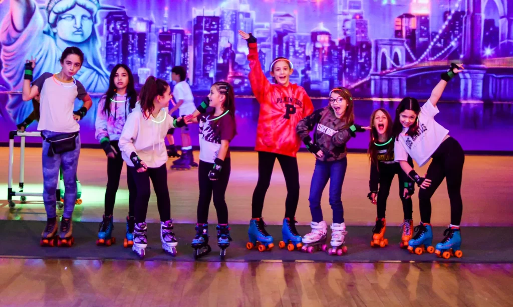 group of girls in line with skates on posing for the camera