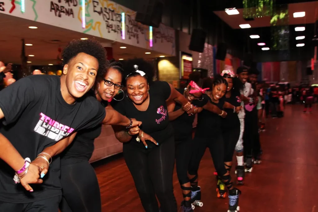 group during adult skate night laughing and having fun while skating