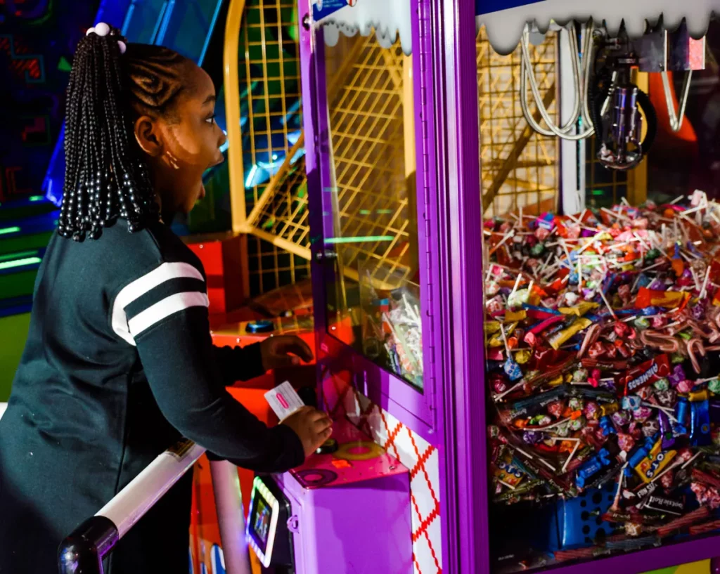 girl winning the arcade candy machine