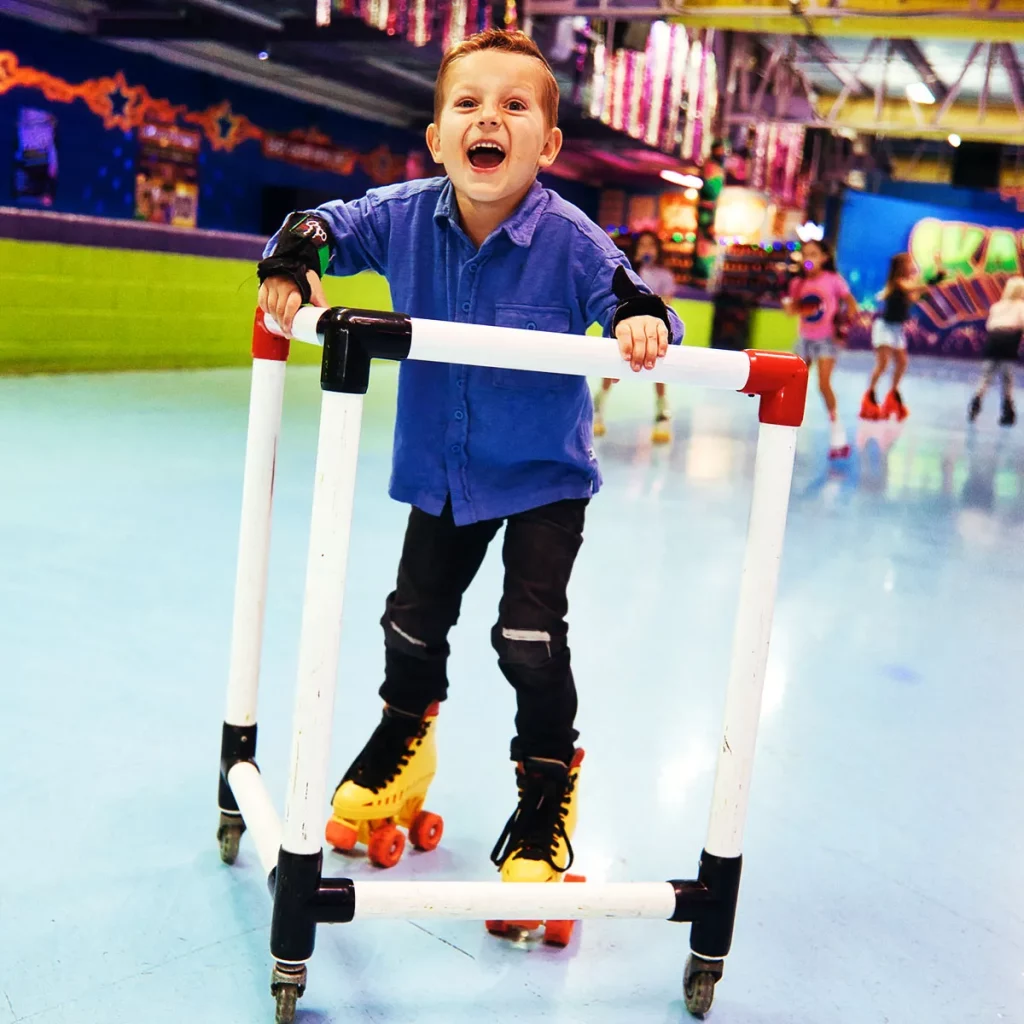 skate mate being used by young boy who is laughing and smiling