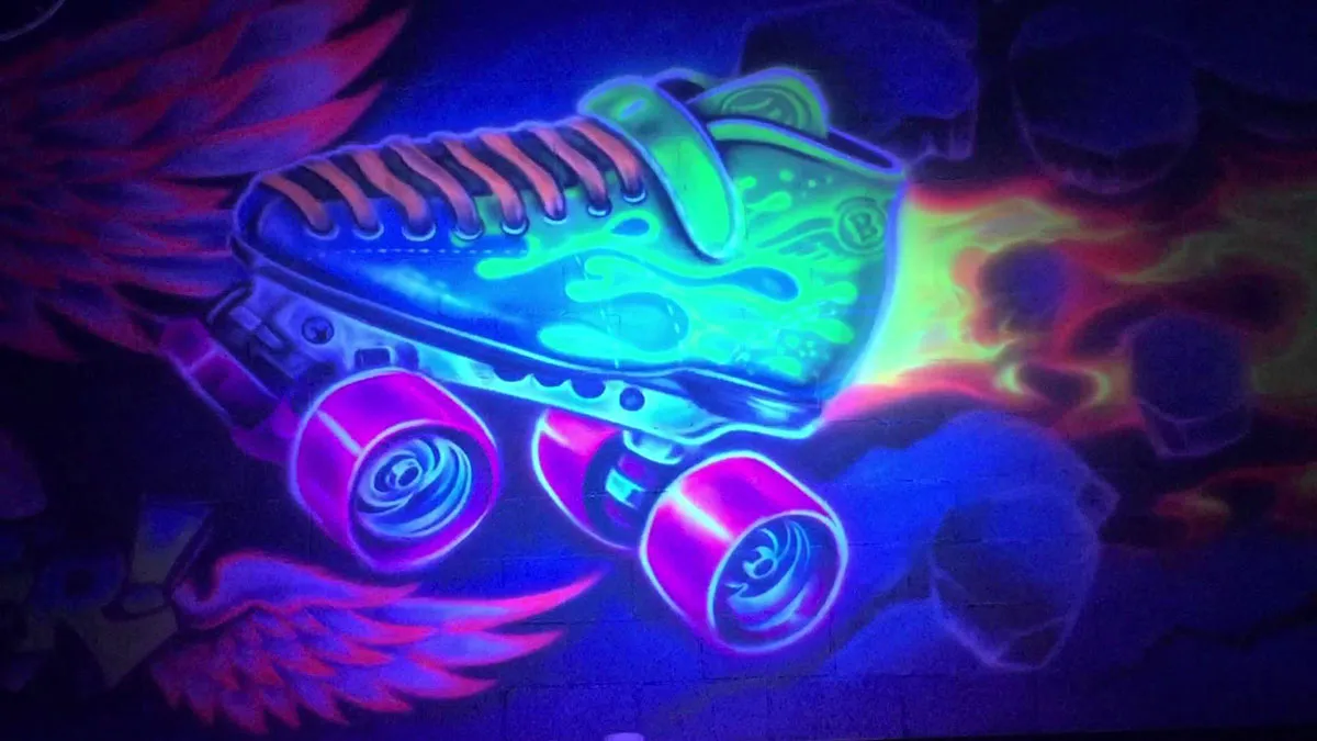 graffiti blacklight art of a roller skate with flames shooting off the back