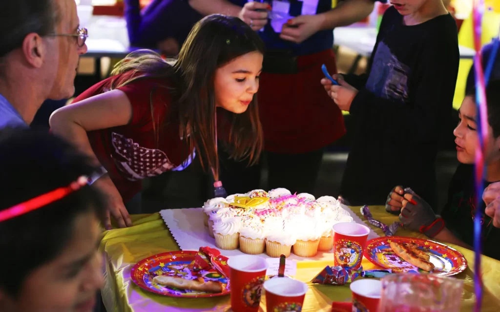 birthday girl blowing out candles