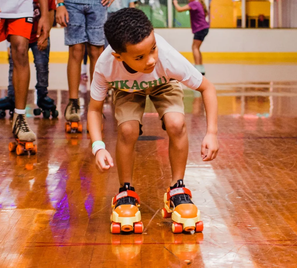 young boy wearing fisher price skates