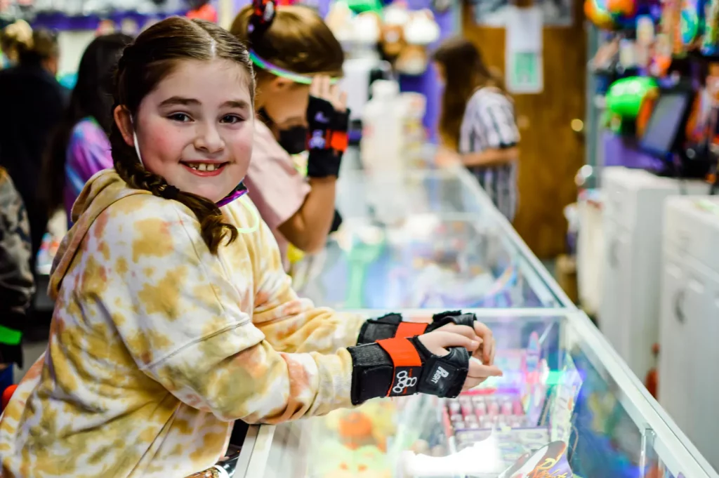 smiling girl waiting her turn at the prize counter