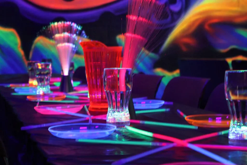 birthday glow party setup with glow sticks and blacklights