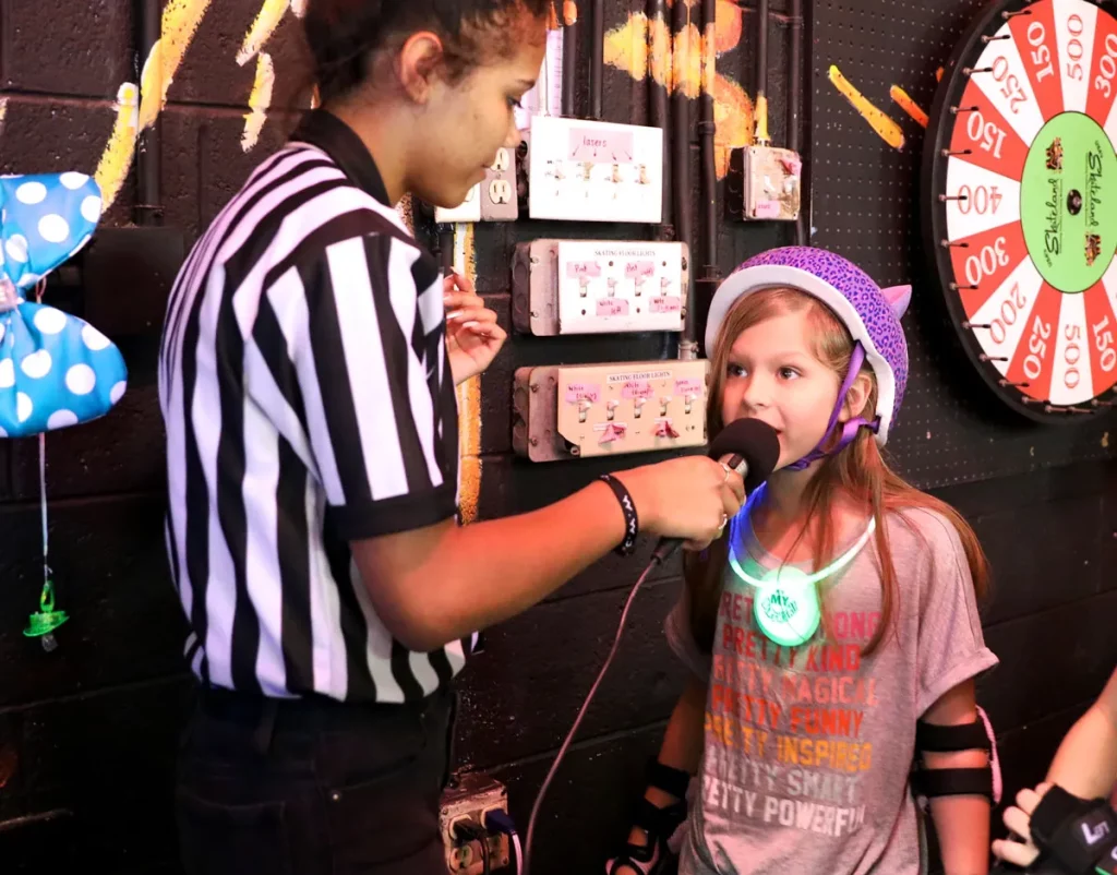 girl about to spin the birthday party wheel